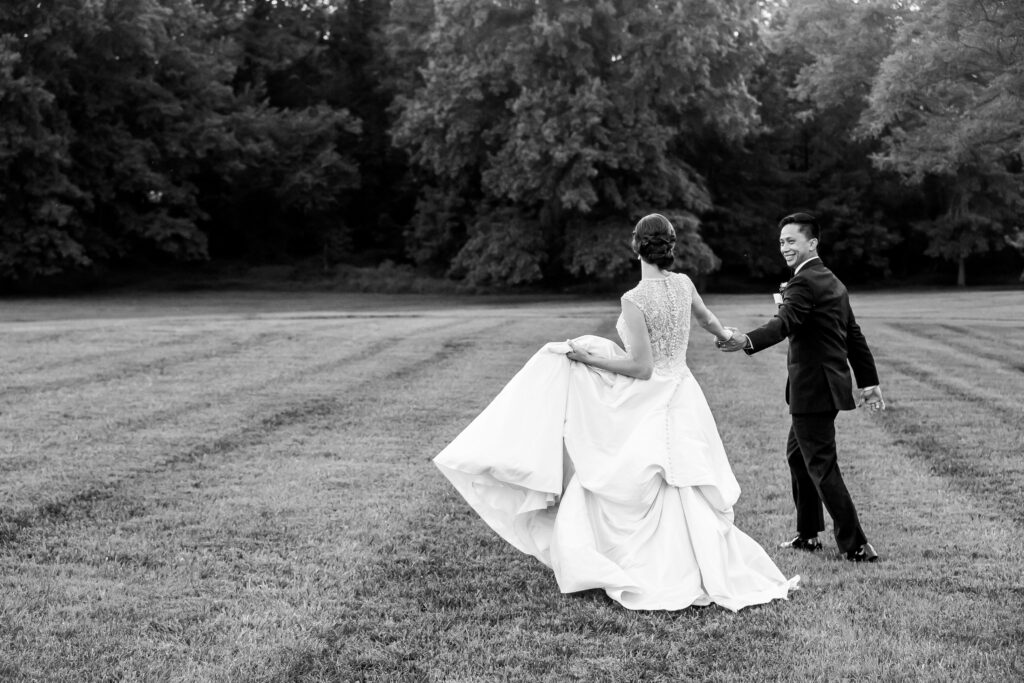 bride and groom dancing in the field
