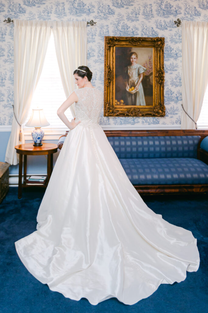 brides dress from behind in blue room