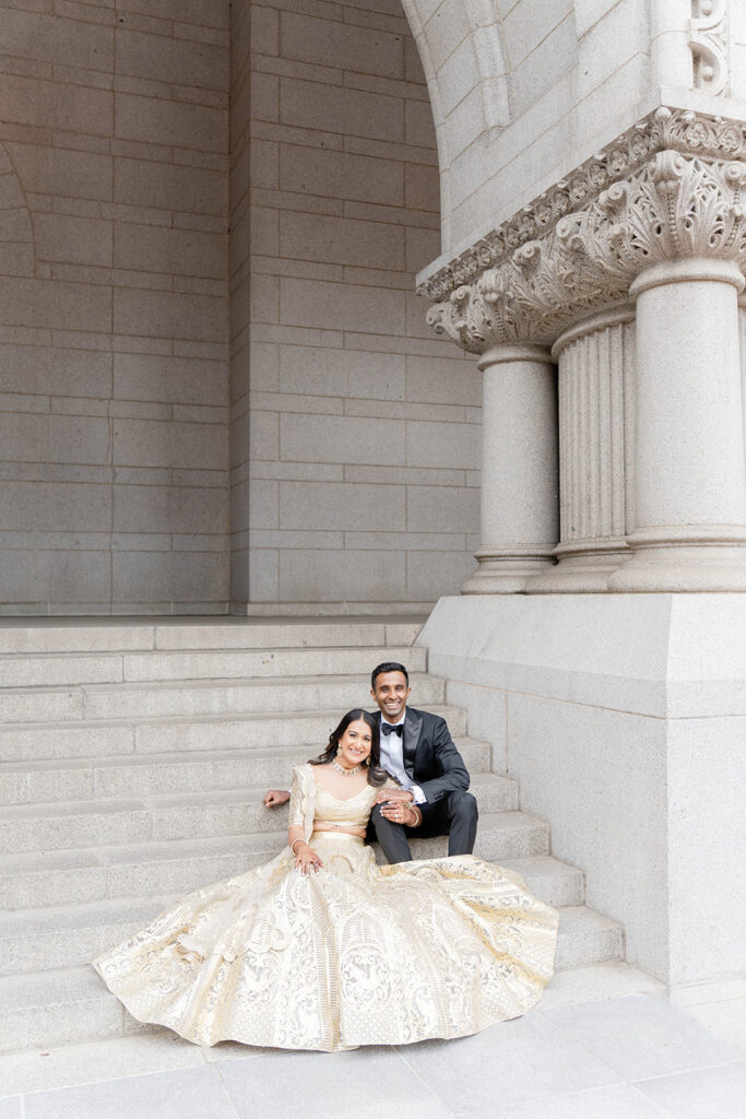 Bride and Groom seating on stairs outside at their Waldorf Astoria DC wedding reception